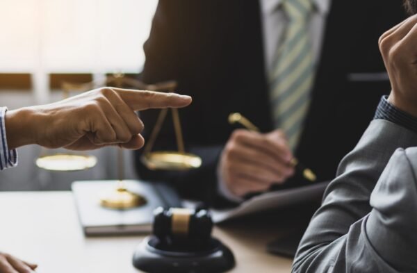 Landlord and tenant having a discussion over a contract to resolve tenant disputes in Canada.