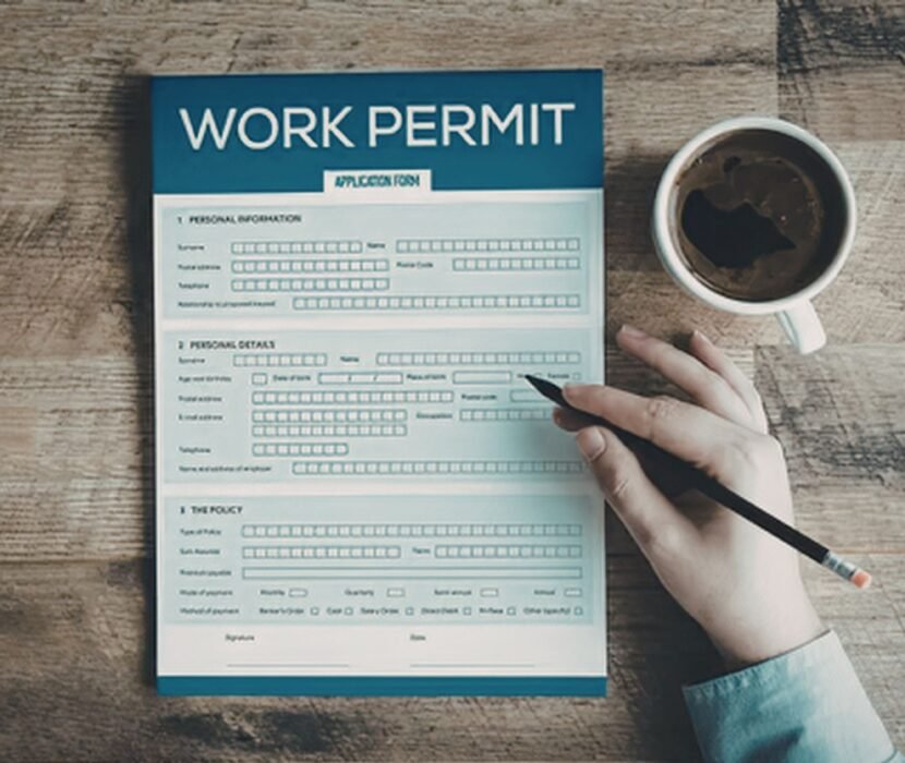 spousal work permit lawyer Regina reviewing Canadian work authorization documents